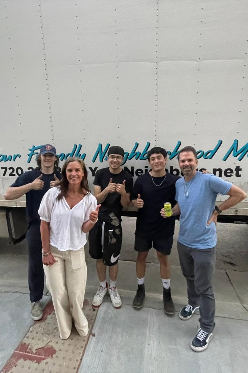 Customers and moving crew gathered by the truck